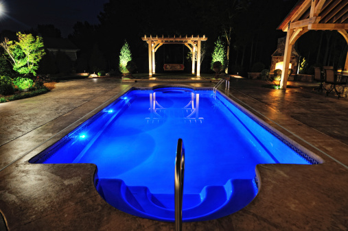 Swimming Pool of Luxury Home Photographed at Night.