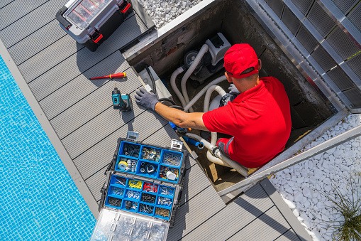 Outdoor Swimming Pool Cleaning and Seasonal Maintenance Performed by a Professional Technician